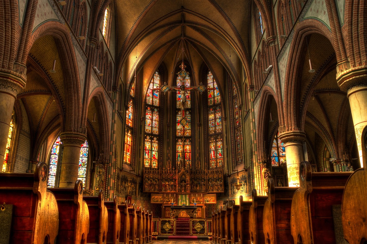 Interior de igreja católica, altar e vitrais, ambiente de oração
