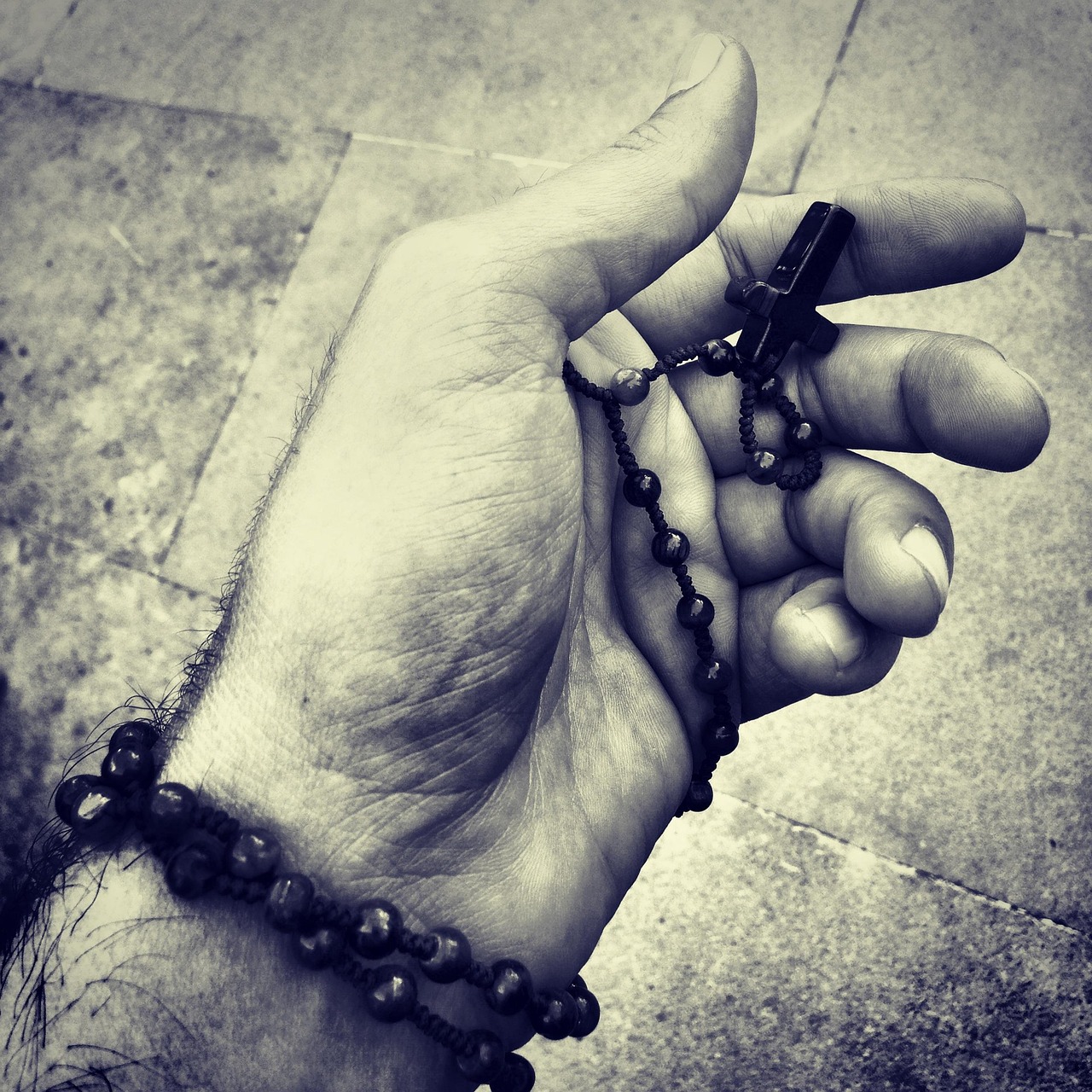 Mãos em oração segurando terço, devoção contemplativa